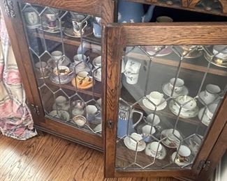 Another view of the lead-glass cabinet and porcelain cups and saucers