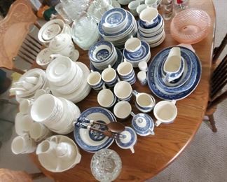 Several sets of dinnerware and collectible glassware.