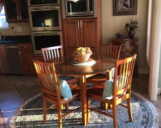 Dining table and four chairs in kitchen area.  Blue fringed rug
SOLD DINING TABLE