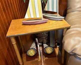 Globe bookends with compasses guide a pair of sailboats across a darling side table.