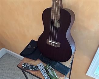 Assortment of interesting pocket knives and acoustic guitar 