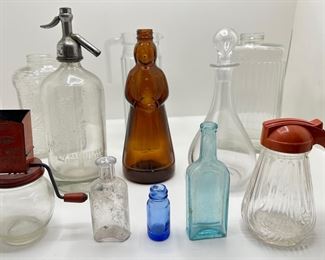 Vintage Glass Bottles Including Seltzer Dispenser & Amber Mrs. Butterworth, Nut Chopper & More
Lot #: 133