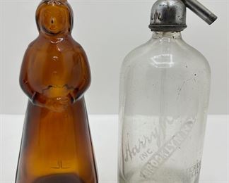 Vintage Glass Bottles Including Seltzer Dispenser & Amber Mrs. Butterworth, Nut Chopper & More
Lot #: 133