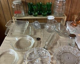 Two vintage glass cookie jars both with tops and one with bell handle, five green vases, glass rolling pin, Pyrex casserole dishes, pie dishes and cut glass