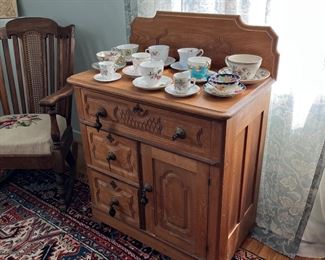 Washstand displaying vintage tea cups and saucers