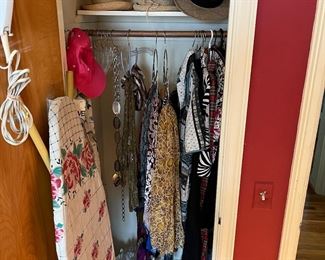 
Women’s clothes, hats and ironing board with iron