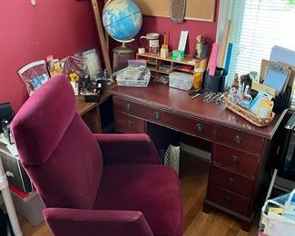 Wooden desk, desk chair, globe and variety of office supplies