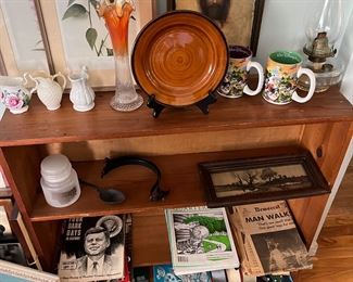 Bookcase, vintage magazines and newspapers, pictures and dishes
