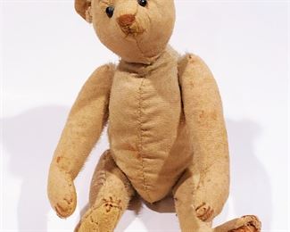 Antique Teddy Bear possibly by Bing or Steiff. It has a black metal tag in its ear. It has a swivel head, moveable arms, legs and stuffed with wood wool ........To register in order to place bids go to www.capitolsalesservices.hibid.com