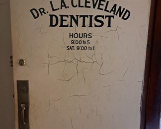 Much vintage building architecture. "Dr. L. A. Cleveland DENTIST" door