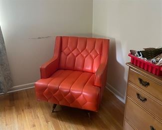 Check out this vintage orange swivel chair.  There is slight damage in the top back corner of the chair.