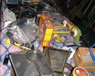Tables in garage are packed with tools and many other items