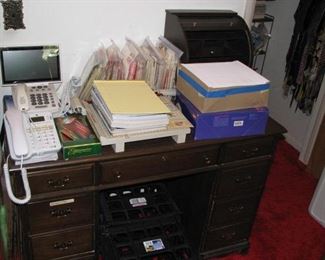 Desk and office supplies also a couple phones, one has a large screen