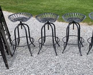 Six Vintage Industrial metal stools and 4 pc set of swiveling Tractor Seat stools