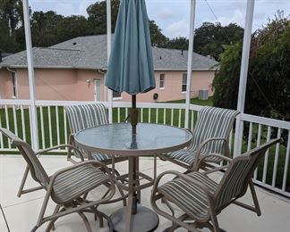 Bar height outdoor dining set w/swivel  chairs and standing umbrella