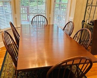 Solid cherry trestle table and 6 chairs. Includes two expansion leaves and table top pads