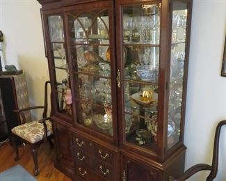 Very nice china cabinet with amble lighted display space and handy enclosed storage below