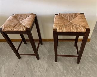 2 straw ripped wooden bar stools, counter height.