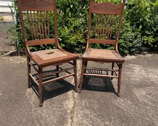 Pair of oak pressed back chairs with caned seats (one seat needs new caning) 40"H x 16"W
