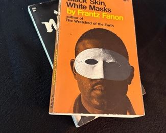 Vintage paperback books including by Frantz Fanon & Dick Gregory