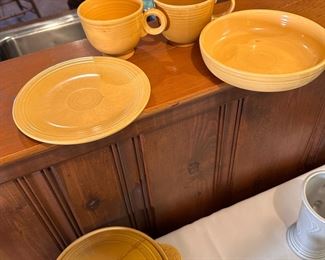 Fiestaware mustard color cups, one saucer and one bowl