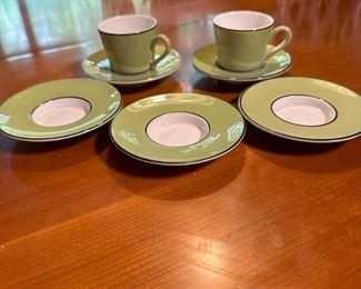 Pair of green demitasse cups and 3 extra saucers