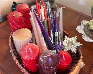 Group of pillar and taper candles in multi-color basket