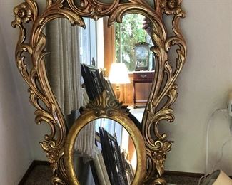 Gilt mirrors, very Hollywood Regency style.