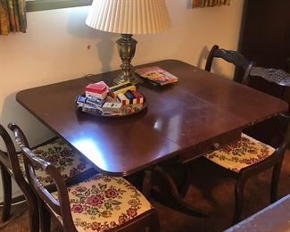 $50. Dining table from the 40s-50s. Four chairs with grape-carved backs and embroidered seats you can easily recover with fabric without sewing. Sides fold down so the table can be console-size.