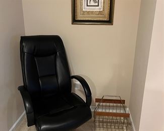 Lower Level:  An ergonomically correct office chair is displayed with a print and mid-century style magazine rack.