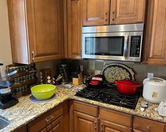 Kitchen:  There are three spice racks; oven potholders; a large red enamel Dutch oven; a rice cooker; and a few other items.