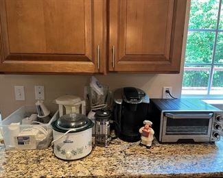 Kitchen:  More small appliances are displayed, including a Presto salad shooter; Rival crock pot; OSTERIZER blender; Keurig coffee machine; and a Cuisinart Toaster oven.