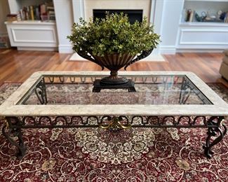 Living Room:  This glass top table is framed by a stone tabletop and supported by an iron frame.  A coordinating side table is nearby.  The greenery is also for sale.  A closer photo of the rug follows.