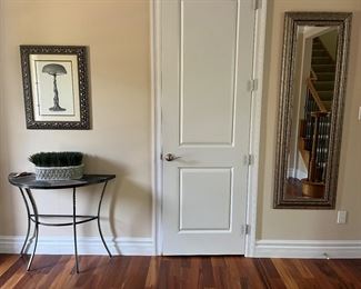 Foyer:  A small Demilune table, faux greenery, and print are to the left of the hall closet.  The beveled wall mirror (21-1/2" x 65") on the right is also for sale.