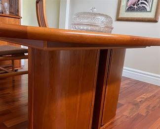 Dining Room:  The table's base is a sturdy oval.  It contains the self/storing table leaf which automatically folds up when the table is extended and folds down when not in use.