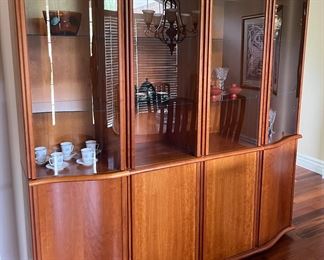 Dining Room:  The Danish Modern (Skovby) teak china cabinet has four slightly curved upper glass doors and four lower doors (the ends are also slightly curved). It measures 80" wide x 19" deep x 76" tall.  Rest assured that it is four separate pieces which make it easier to move upon purchase.  The table/chairs and cabinet are priced as a set.