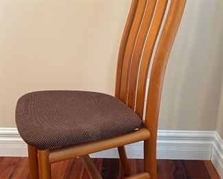 Dining Room:  Here is one of the six teak dining chairs.  Notice the "wave" of the chair's back and  its sturdy frame.