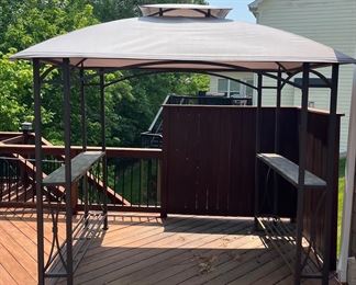 Deck Off Sun Room:  A 5'  x  8' canvas top and iron frame gazebo has two side counters.  The next photo shows the under side of the roof.