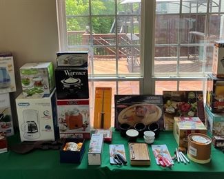 Sun Room:  There are numerous kitchen items and small appliances, many new and  still in their original boxes. A couple of sample photos follow.