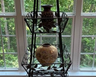 Sun Room:  A quality 74" folding three-shelf iron/glass etagere displays two hand carved high-relief elephant vases (a closer photo follows)  and a gold ceramic vase.