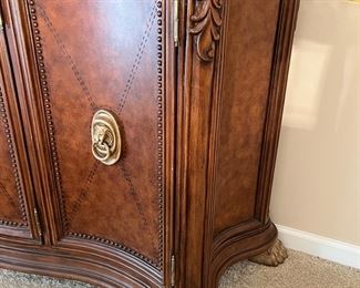 Lower Level:  Notice the large lion head door pulls, beaded door panel trim, corner carving,  and hairy lion paw feet on the cabinet.