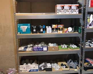 Lower Level-Storage Room:  This is the Light Bulb Department--many choices!  The metal shelf unit (48" wide x 18"deep x 84" tall) is also for sale; another metal shelf unit to the right is also available and holds  many painting supplies. 