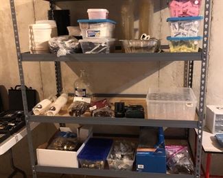 Lower Level-Storage Room:  Another shelf unit (48" wide x 24" deep x 72" tall) is also for sale.  It displays ... plasticware, paper goods, sugar and sweeteners, as well as door knobs and locks!