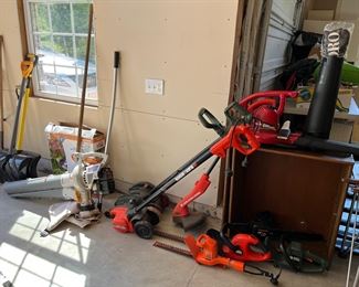 Garage:  Edgers, trimmers, and a Blow Vac are shown near a few shovels.