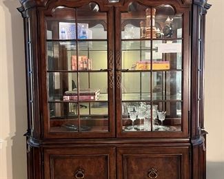 Lower Level: This Thomasville "Hills of Tuscany" display cabinet is actually two pieces.  It has two upper center glass doors which open to three glass shelves.  The back is a mirror.  There are two lower doors as well.  It measures 71" wide x 21" deep x 95" tall at the center point.  Cabinets are great to display books, liquor, silver, china and any of your collections.  (Note:  The lights in the cabinet go on and off by touching the interior hardware.)  Please note that large items like this can be removed upon purchase through the glass sliding doors and up the yard—-no need to carry it up the stairs.