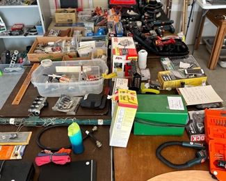 Garage:  Eight card tables display an assortment of hardware; many drills; saws; a mechanics "Creeper"; and lots of miscellaneous. 