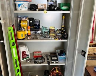 Garage: This storage cabinet [also not for sale] displays a sander; flashlights; and electrical items. Nearby are a couple of levels.