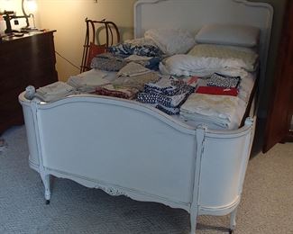 Beautiful wood full size bed filled with bedding