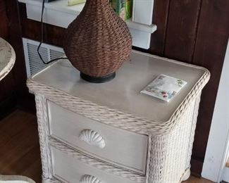 Pretty wicker nightstand with shell drawer pulls; table lamps
