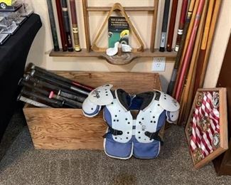 A Large Selection of Aluminum Bats and Football Shoulder Pads.